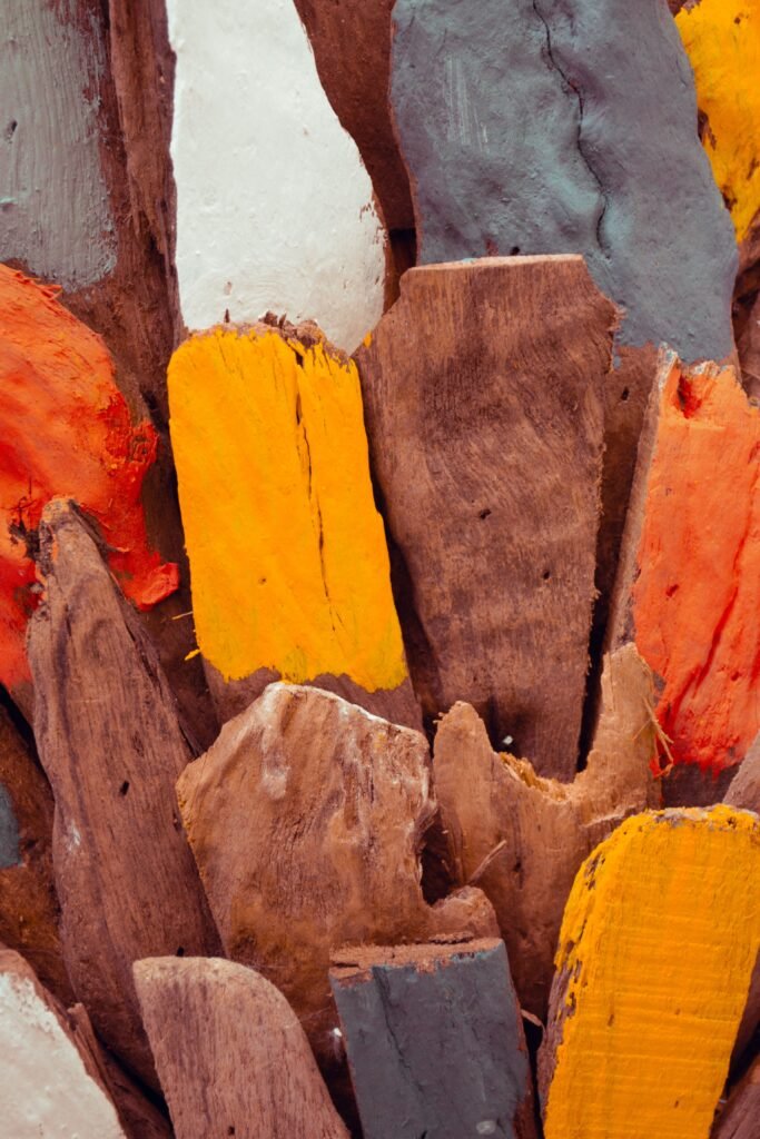 Vivid abstract art with painted wooden planks in vibrant colors, vertical shot.